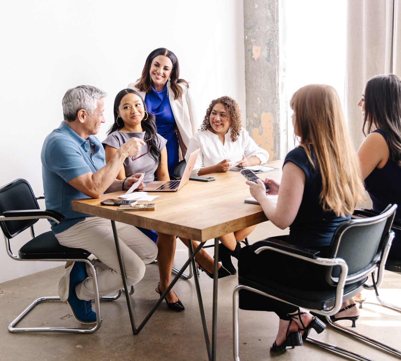 Elevated by Mekky Media trainers working with a client team around a conference table