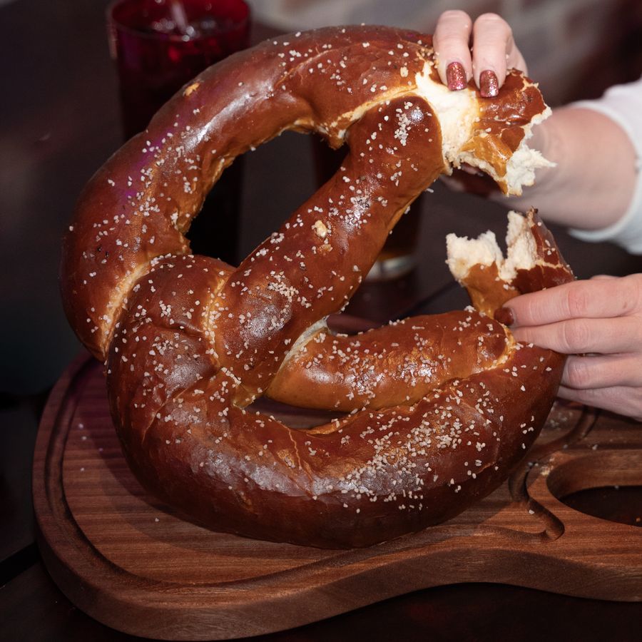 Giant soft pretzel served on a wooden board